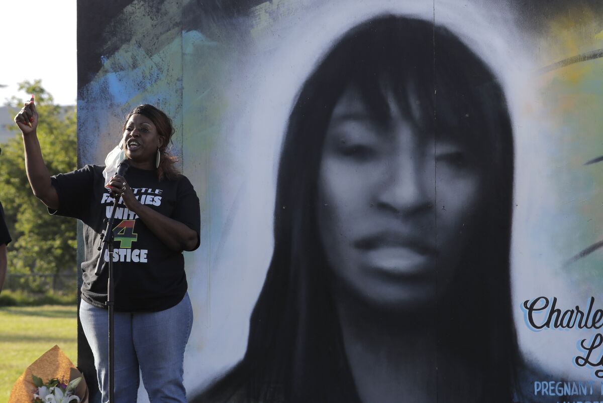 FILE - Tonya Isabell, left, speaks on June 18, 2020, during a vigil for her cousin Charleena Lyles, pictured at right, on the third anniversary of her death, in Seattle. An inquest jury found Wednesday, July 6, 2022, that two Seattle police officers were justified in fatally shooting Lyles, a mentally unstable, pregnant, Black mother of four children, inside her apartment when she menaced them with knives in 2017. (AP Photo/Ted S. Warren,File)