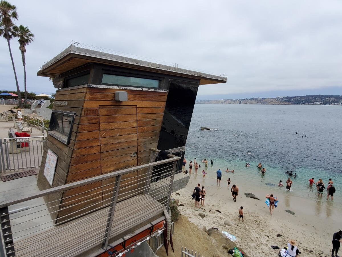 Lifeguards watch over La Jolla Cove from a tower at the edge of Scripps Park.