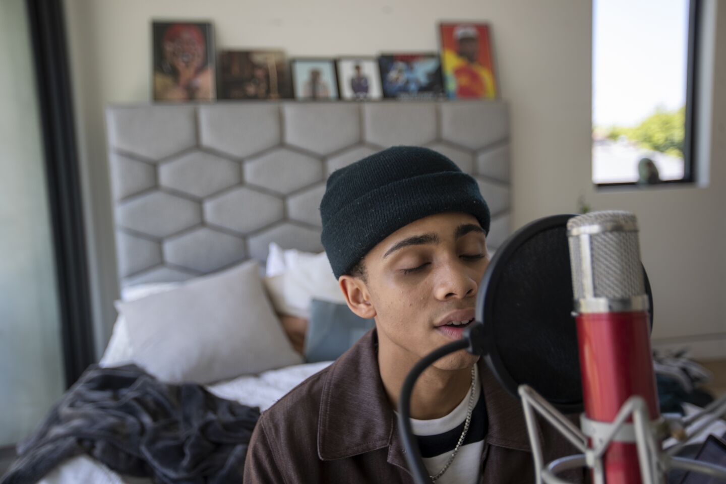Bryce Xavier, 18, practices singing in his room at the Vault House.