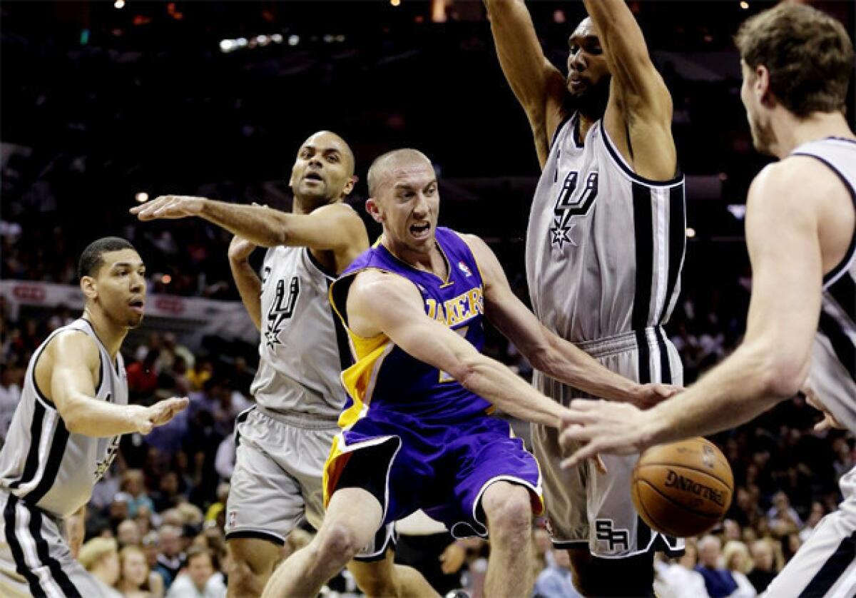 Lakers guard Steve Blake, center, is surrounded by San Antonio Spurs defenders.