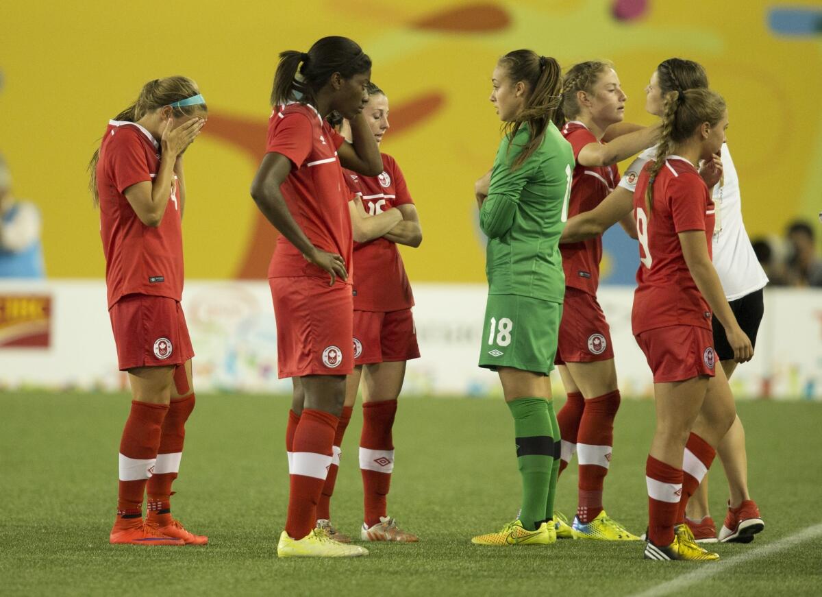 Players of Canada react after losing 1-2 to Mexico in the 2015 Pan Am Games women's bronze medal soccer match in Hamilton, Ontario, Friday, July 24, 2015. (Peter Power/The Canadian Press via AP)