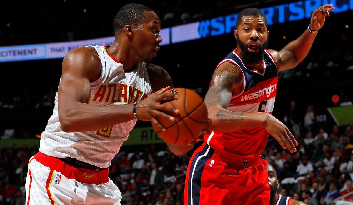 Atlanta Hawks' Dwight Howard, left, grabs a rebound against Washington Wizards' Markieff Morris during the game Thursday.