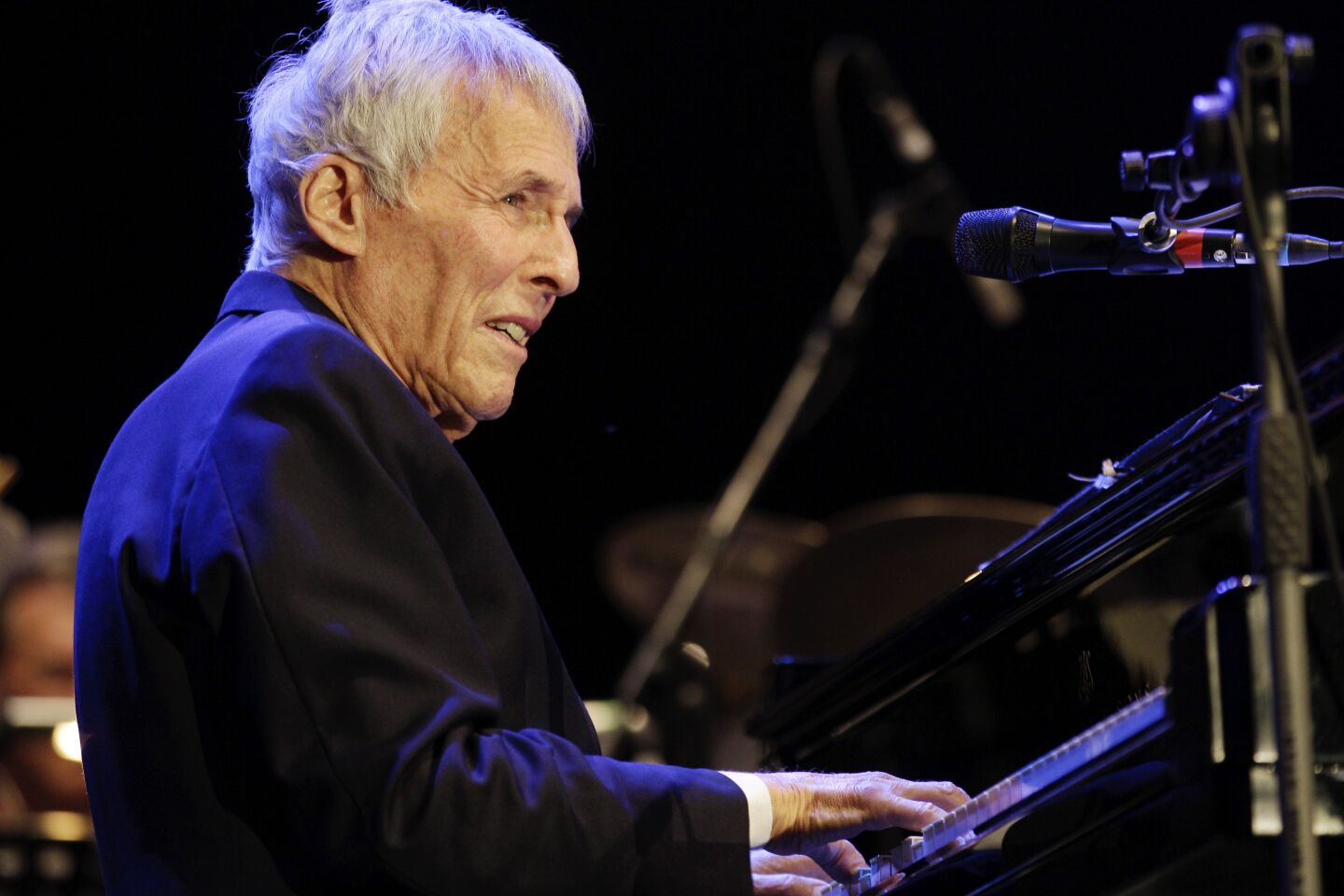 Burt Bacharach onstage playing the piano