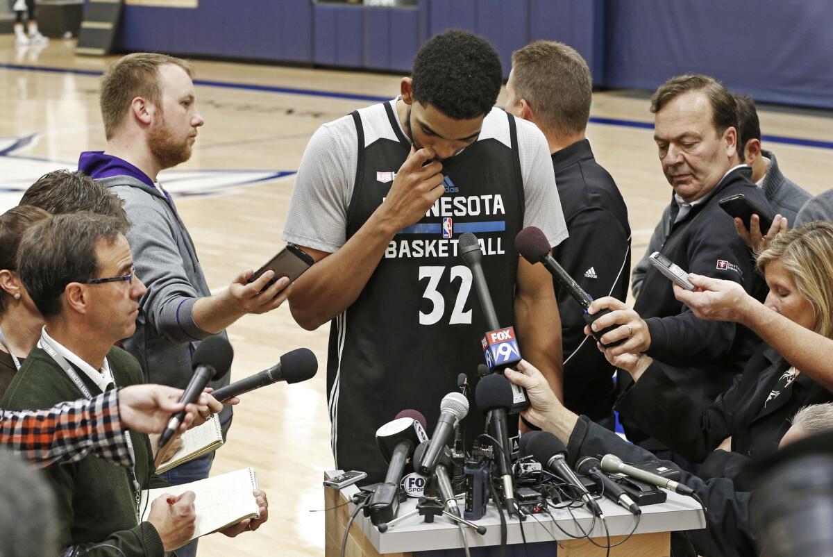 Timberwolves' forward Karl-Anthony Towns composes himself as he addresses the media on Monday about the death of head coach Flip Saunders.