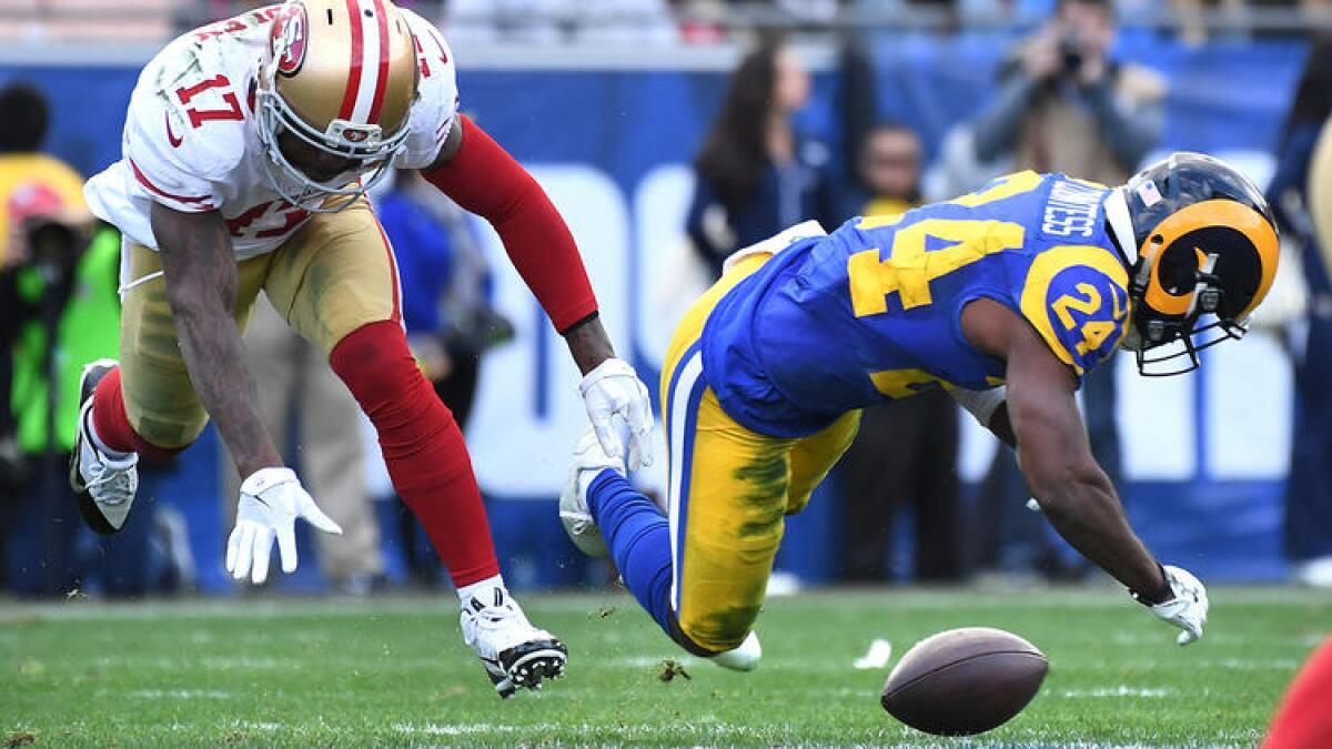 Rams defensive back Blake Countess, right, is called for pass interference as he breaks up a pass during the second quarter. To see more images from the game, click on the photo above.