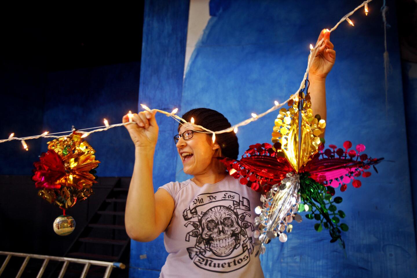 Lupe Legaspi, 33, of Montebello helps decorate the Casa del Mexicano, which recently opened its doors to the public for the first time since the new owner, the East Los Angeles Community Corp., took over the historic building where the Mexican elite once came to dance and be seen.