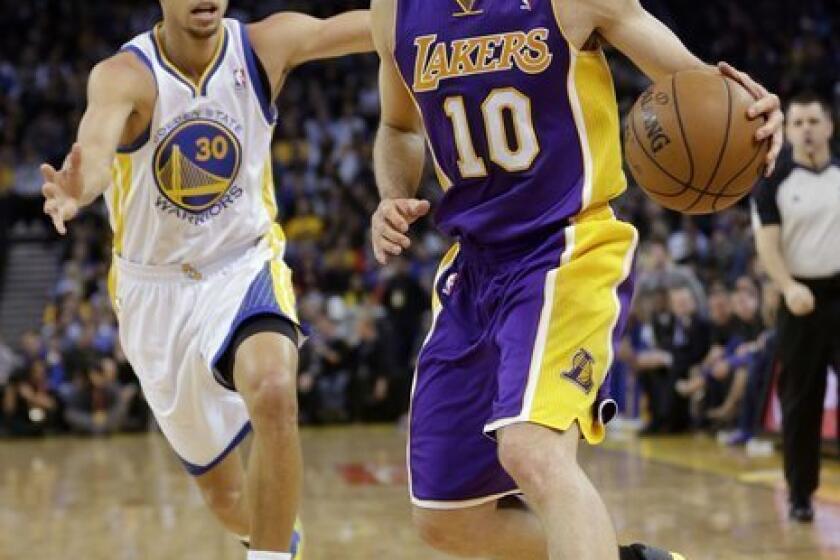 Steve Nash dribbles past the Golden State Warriors' Stephen Curry during a game in Oakland.