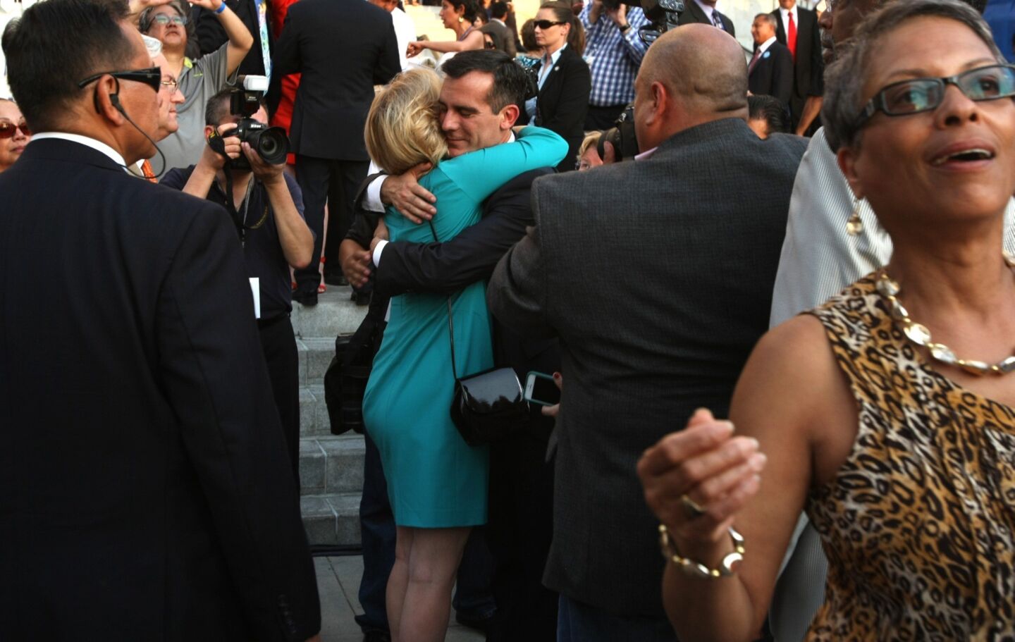 Eric Garcetti receives a hug of support from former mayoral opponent and departing City Controller Wendy Greuel, who watched the inauguration from the audience but did not speak.