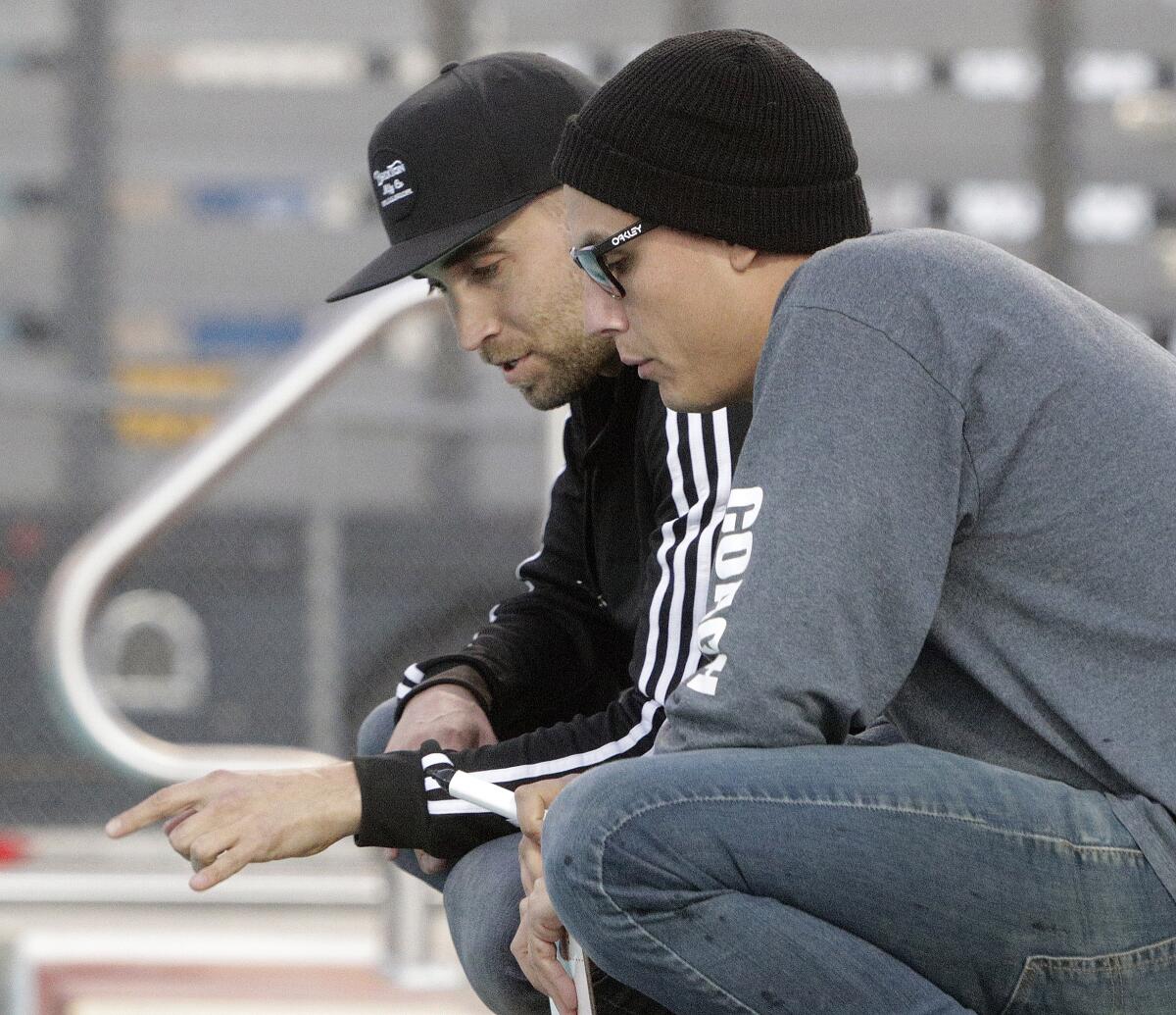 Burroughs High girls' water polo coach Jacob Cook, left, and assistant coach Martin Ortega-Jennison and the Indians will play in a CIF quarterfinal playoff match Saturday against host California.