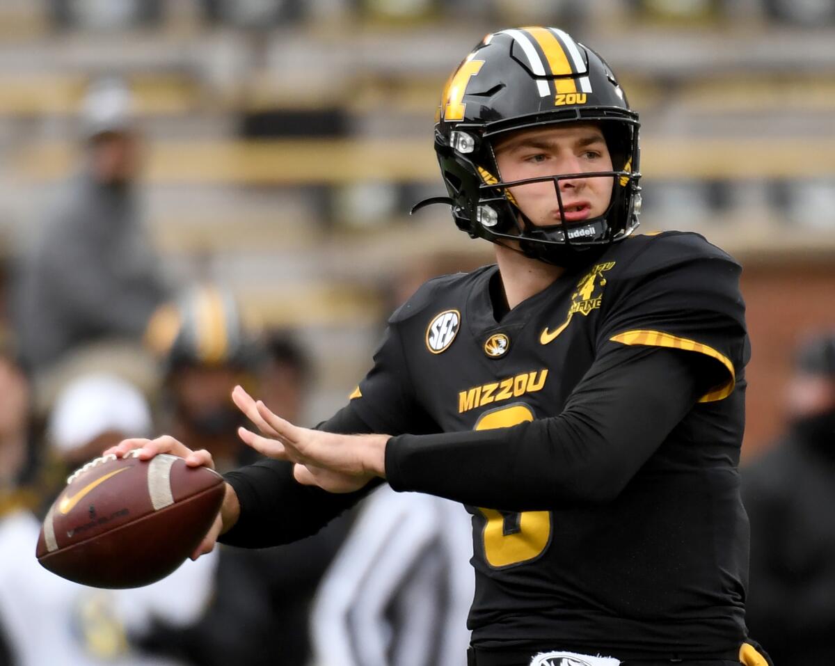 FILE - In this Dec. 12, 2020, file photo, Missouri quarterback Connor Bazelak throws during the first half of an NCAA college football game against Georgia in Columbia, Mo. Bazelak is back under center after wresting control of the quarterback job from Shawn Robinson about five quarters into last season. (AP Photo/L.G. Patterson, File)