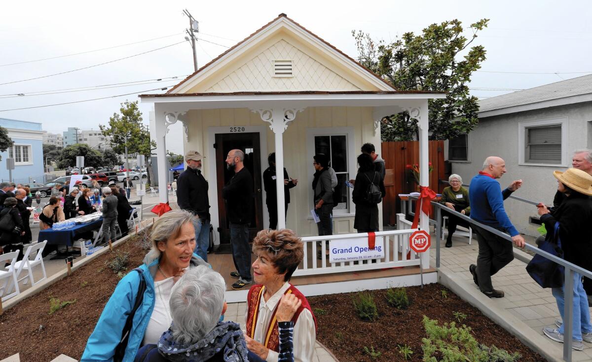 Santa Monica residents gather at a "shotgun" house that had been slated for demolition but which is now the Santa Monica Conservancy's Preservation Resource Center.