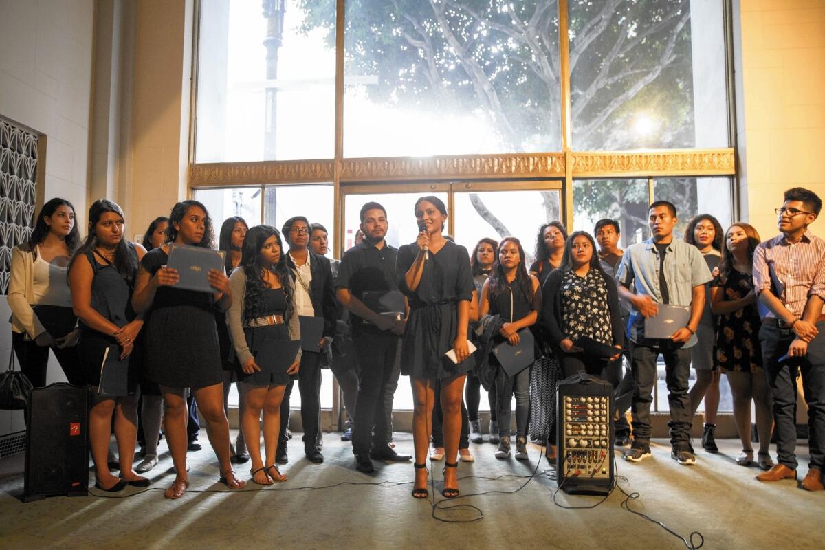 Dream Summer participants receive certificates during the program's graduation ceremony Thursday.