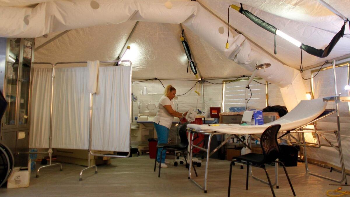 A nurse prepares a room in a makeshift emergency room in Vieques, Puerto Rico. The only hospital available for the 9,000 residents of Vieques was damaged by Hurricane Maria and had to be closed.
