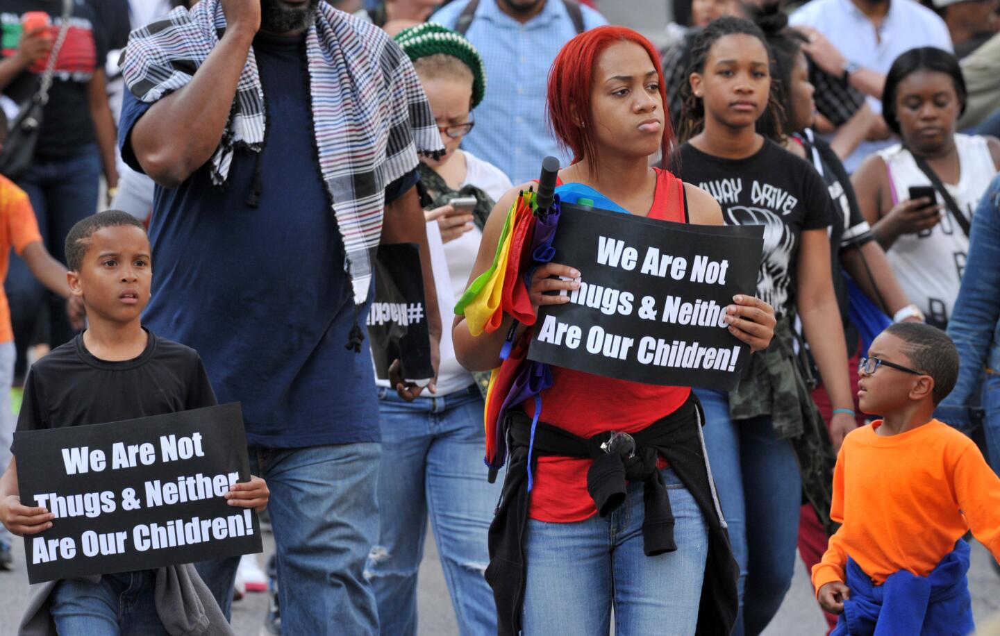Holding signs reading, "We are not thugs & neither are our children," a group of protesters march from Penn North to City Hall on Thursday in Baltimore.