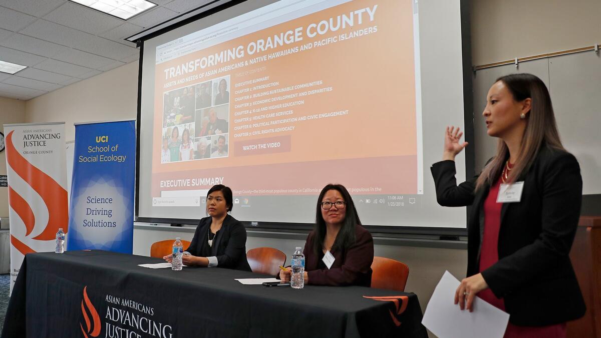 From left, Laureen Hom, co-author of Transforming Orange County, and Mary Anne Foo, Orange County Asian Pacific Community Alliance executive director, look on as Sylvia Kim, Asian American Advancing Justice Orange County regional director, speaks at UC Irvine.