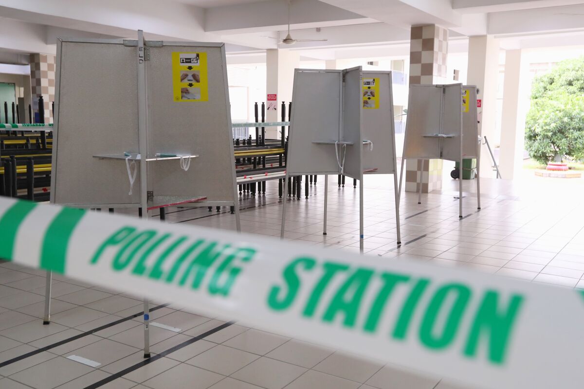 In this handout photo provided by the Ministry of Communications and Information, polling stations have been set up at Chung Cheng high school Thursday, July 9, 2020 in Singapore. Friday's general election in Singapore will be the first in Southeast Asia since the coronavirus pandemic began, with the health crisis and a grim economy expected to bolster Prime Minister Lee Hsien Loong's party and extend its unbroken rule. (Singapore Ministry of Communications and Information via AP)