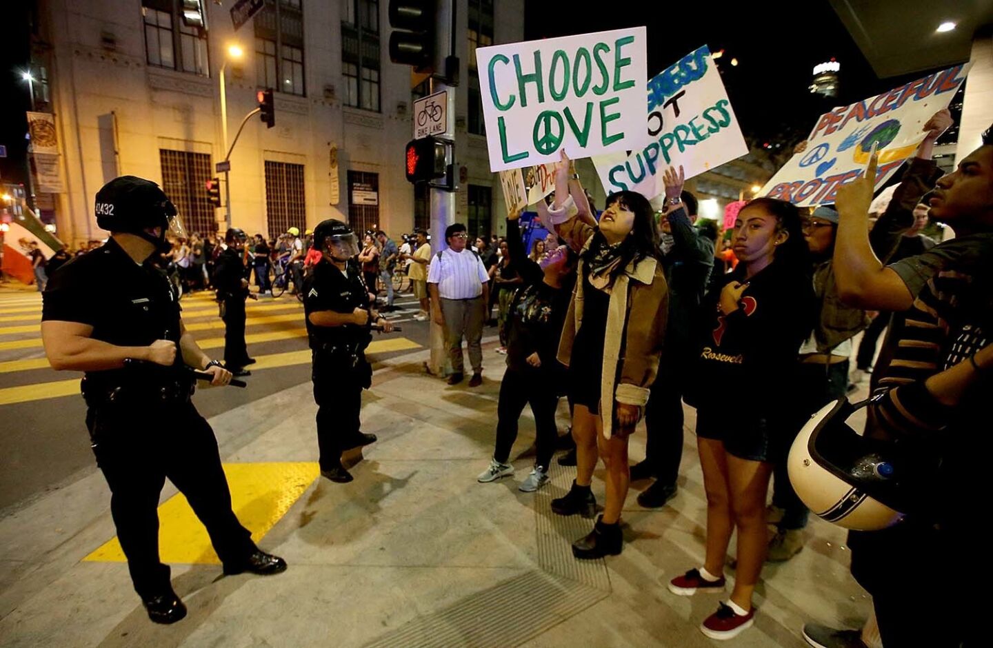Protesters chant and wave signs as LAPD officers halt their march through downtown Los Angeles.