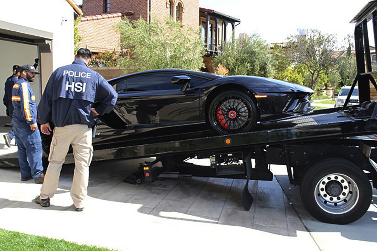 Special agents with HSI Los Angeles's El Camino Real Financial Crimes Task Force seize a Lamborghini from Mustafa Qadiri