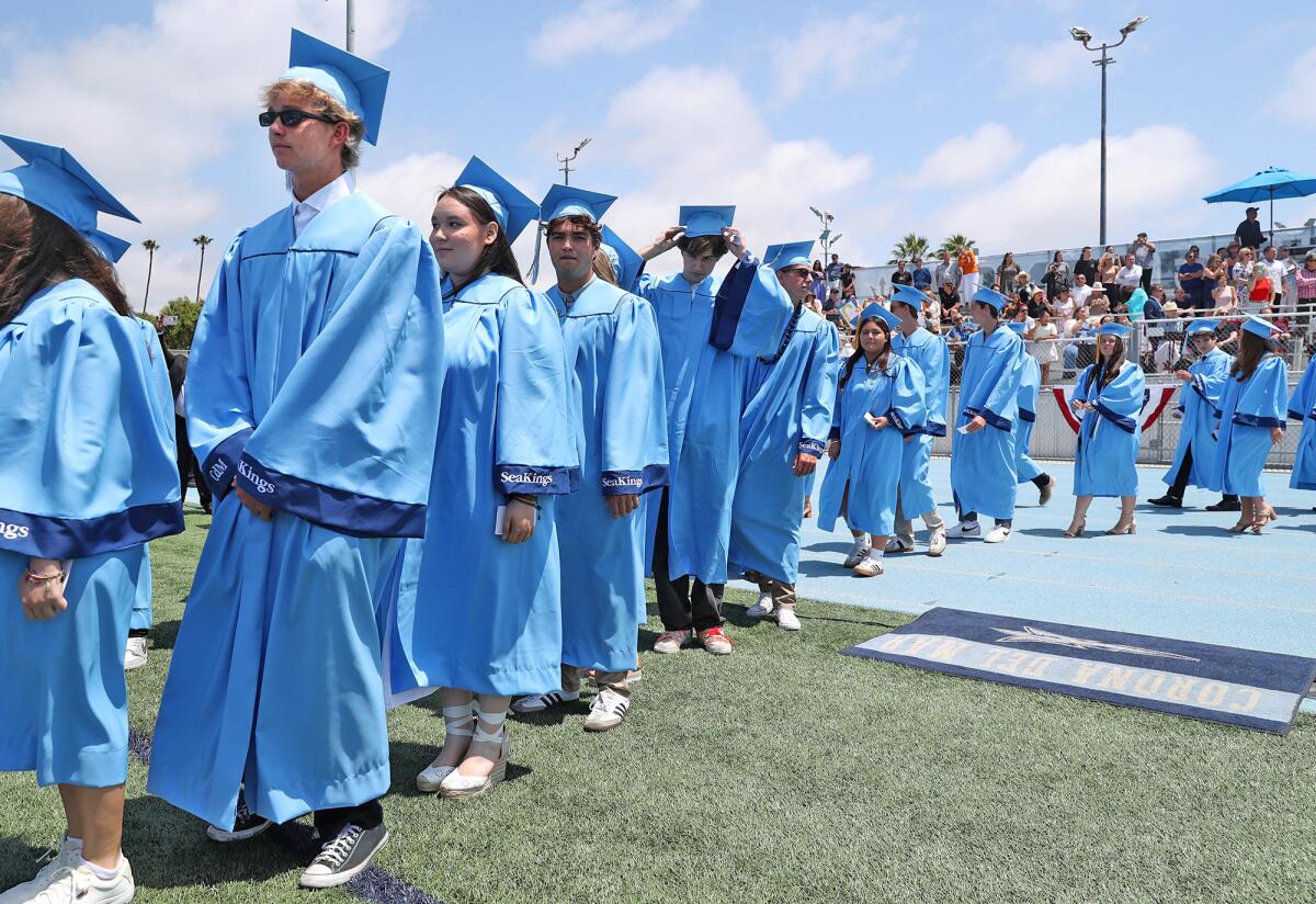 Graduates parade past parents and guests.
