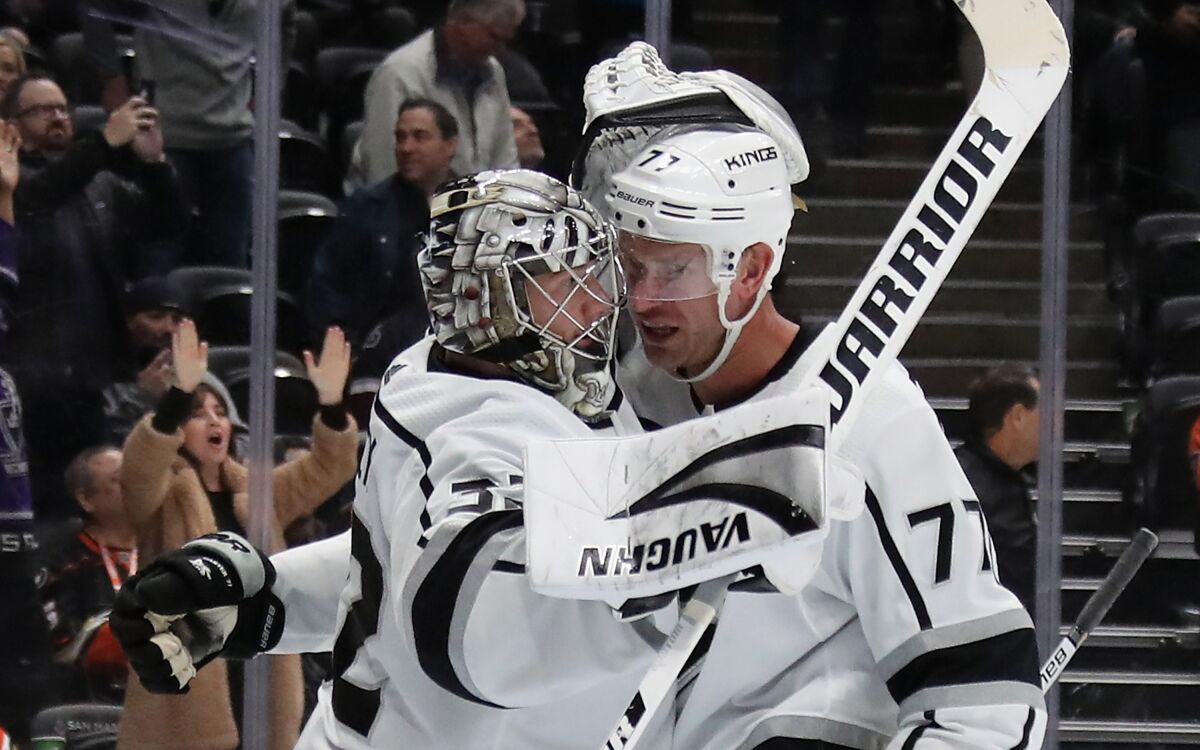 Kings goaltender Jonathan Quick and center Jeff Carter celebrate a 2-1 victory over the Ducks.