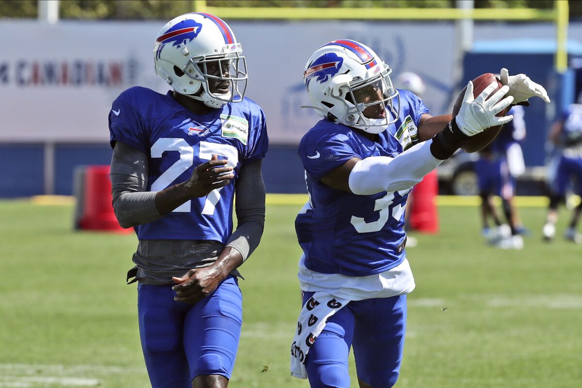 FILE - In this Aug. 31, 2020, file photo, Buffalo Bills cornerback Levi Wallace (39) catches a pass in front of cornerback Tre'Davious White (27) during NFL football practice in Orchard Park, N.Y. (James P. McCoy/Buffalo News via AP, Pool, File)