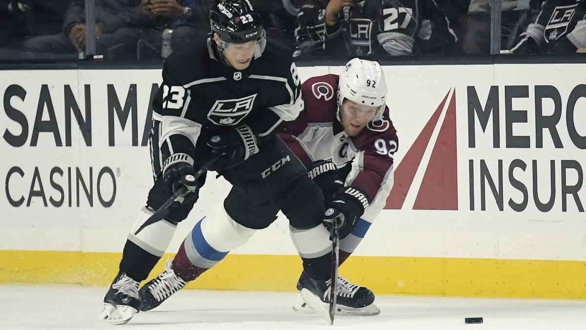 Kings right wing Dustin Brown (23) and Avalanche left wing Gabriel Landeskog battle for the puck during the second period Wednesday night.