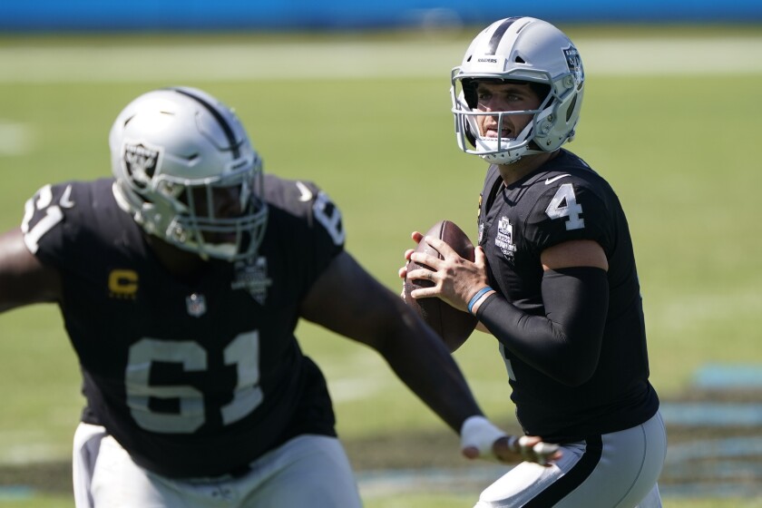 Las Vegas Raiders quarterback Derek Carr looks to pass against the Carolina Panthers.