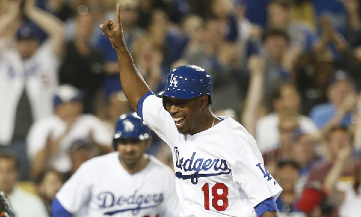 Dodgers pinch hitter Chone Figgins celebrates as he scores the winning run on a double by Carl Crawford in the 10th inning of the Dodgers' 3-2 win over the Detroit Tigers on Tuesday.