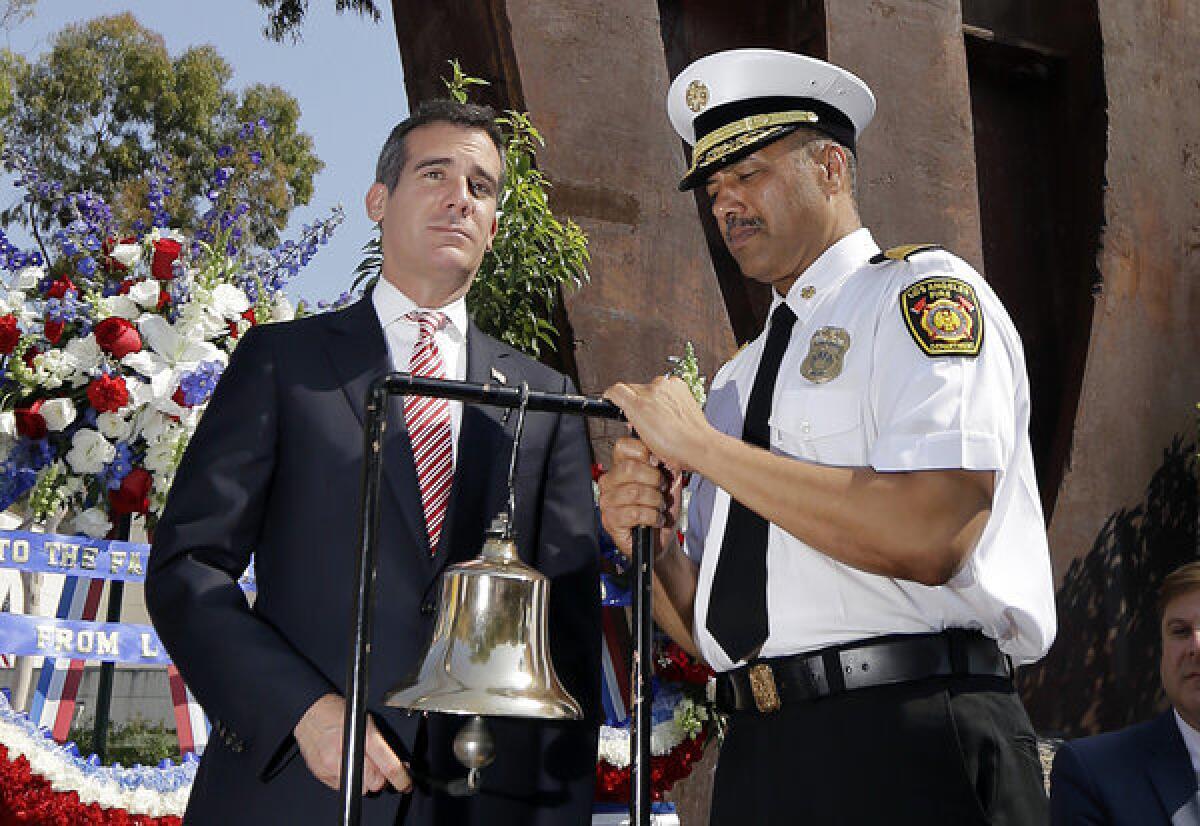 Mayor Eric Garcetti, left, and fire chief Brian Cummings toll a fire bell at a ceremony last month commemorating the 10-year anniversary of the terrorist attacks on the World Trade Center and Pentagon.