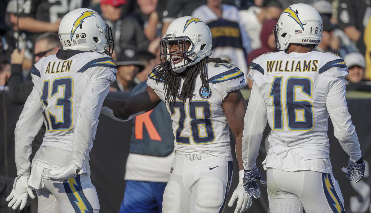 Chargers running back Melvin Gordon celebrates with teammates Keenan Allen and Tyrell Williams after scoring a touchdown against the Raiders on Nov. 11.