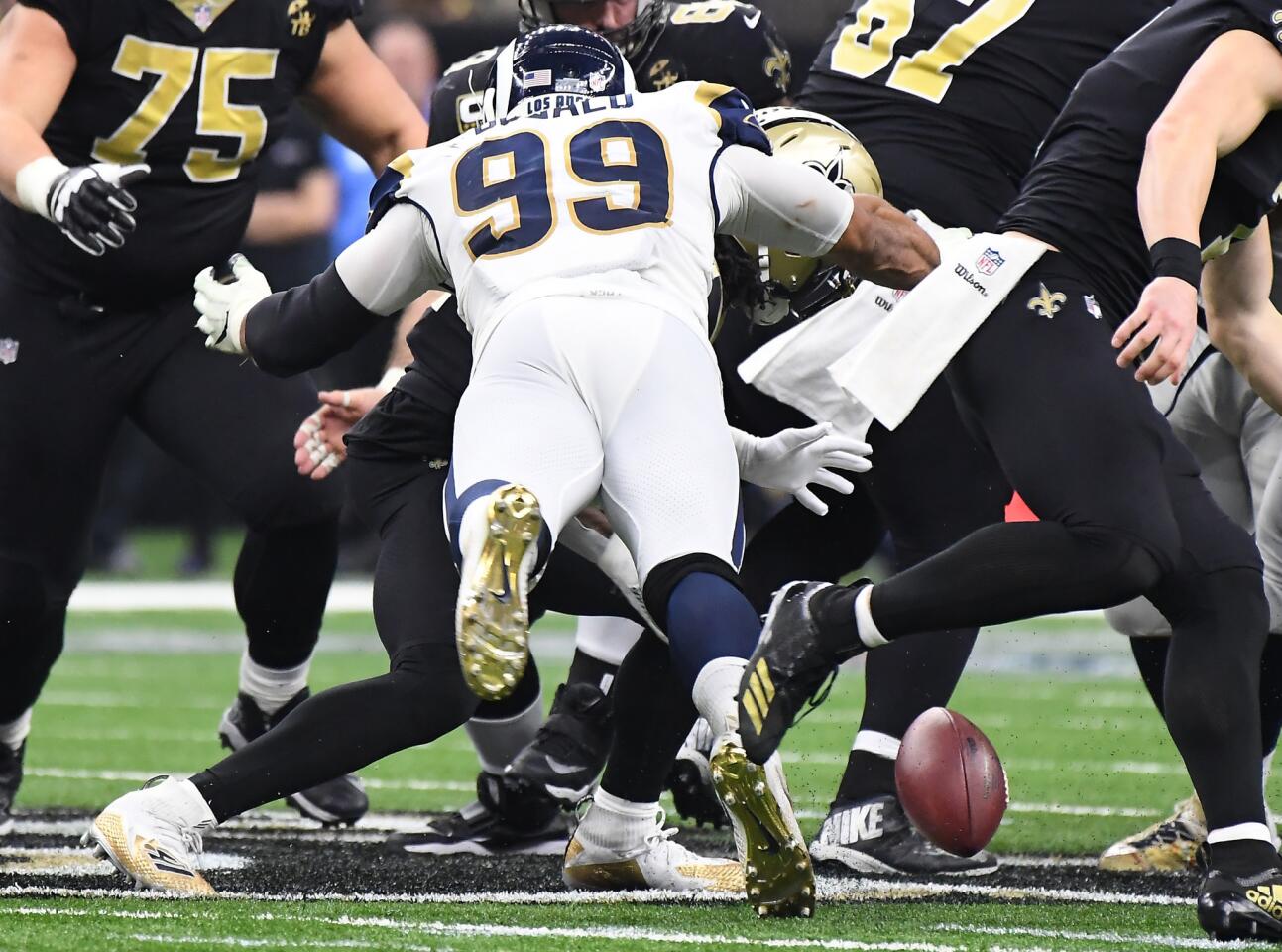 Rams defensive end Aaron Donald strips the ball of New Orleans Saints running back Alvin Kamara in the third quarter in the NFC Championship at the Superdome in New Orleans Sunday. Kamara recovered the ball.