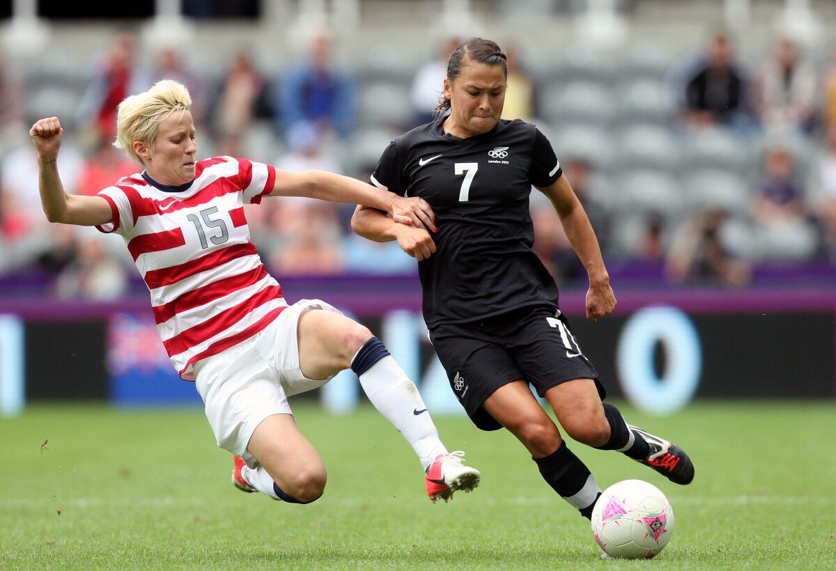 U.S. forward Megan Rapinoe, left, vies for the ball with New Zealand's Ali Riley during an Olympic quarterfinal match.